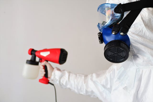 man spray painting the wall